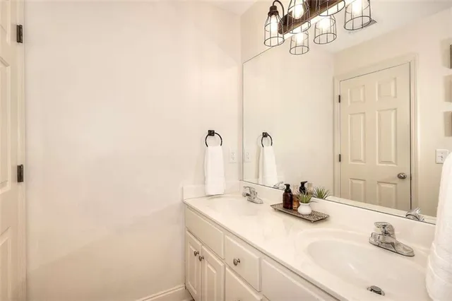 a bedroom with a bed a couch and a large window