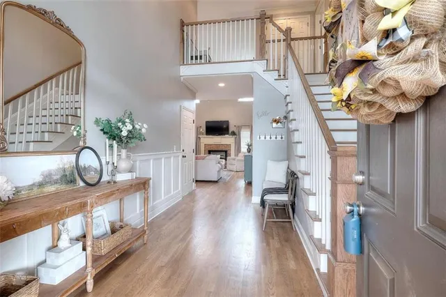 a view of entryway and hall with wooden floor