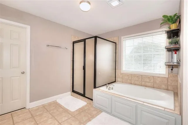 a spacious bathroom with a mirror a sink and a shower