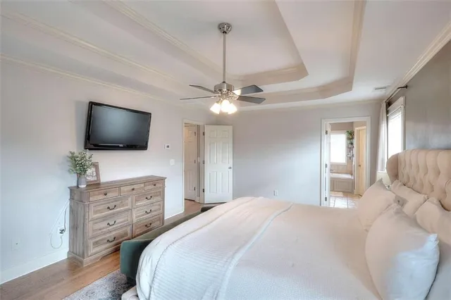 a bedroom with furniture and a flat screen tv