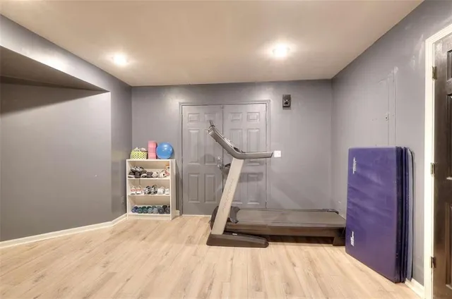 a view of a hallway with wooden floor and windows