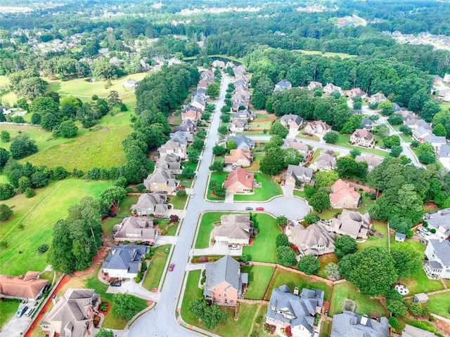a view of a house with a backyard