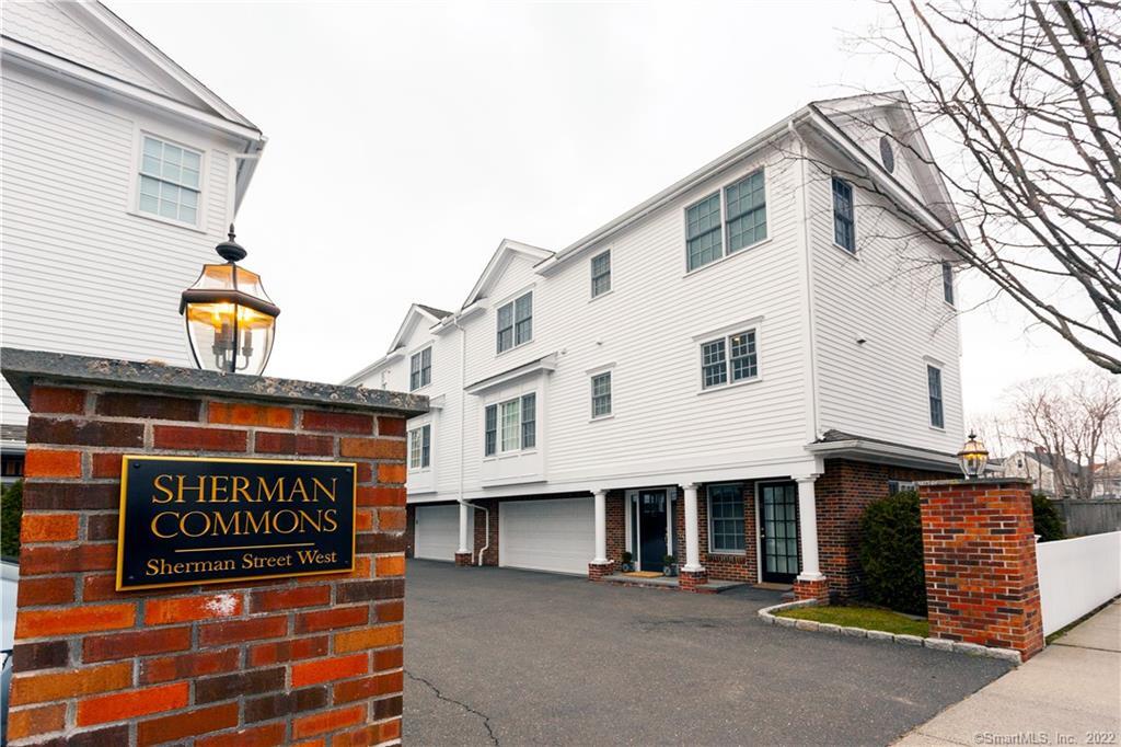 53 Sherman Street West, Unit 53 Fairfield, CT 06824 - Photo 1 of 1 a sign on the side of a building