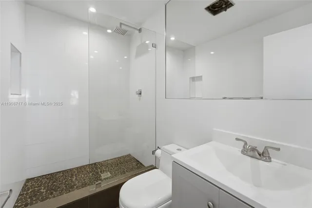 a bathroom with a sink toilet and shower