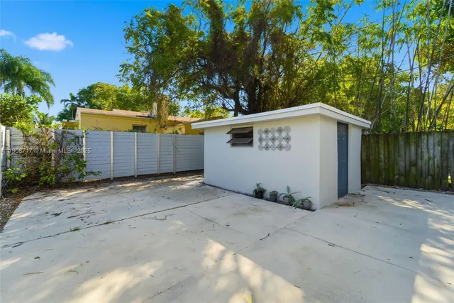 a view of backyard with a barn and a garage