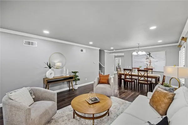 a living room with furniture kitchen and a table