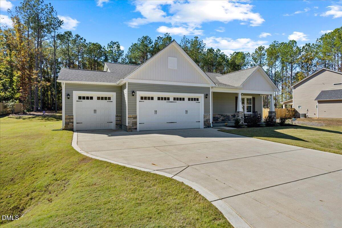 189 Red River Drive Selma, NC 27576 - Photo 1 of 31 a front view of a house with a garden and garage
