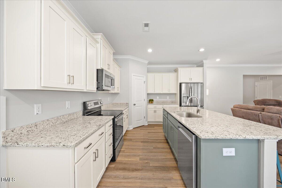 189 Red River Drive Selma, NC 27576 - Photo 10 of 31 a kitchen with stainless steel appliances granite countertop a sink stove and refrigerator
