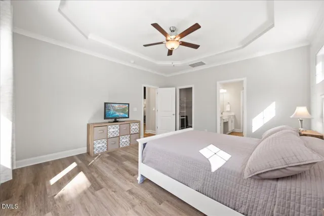 a living room with a bed furniture and a flat screen tv