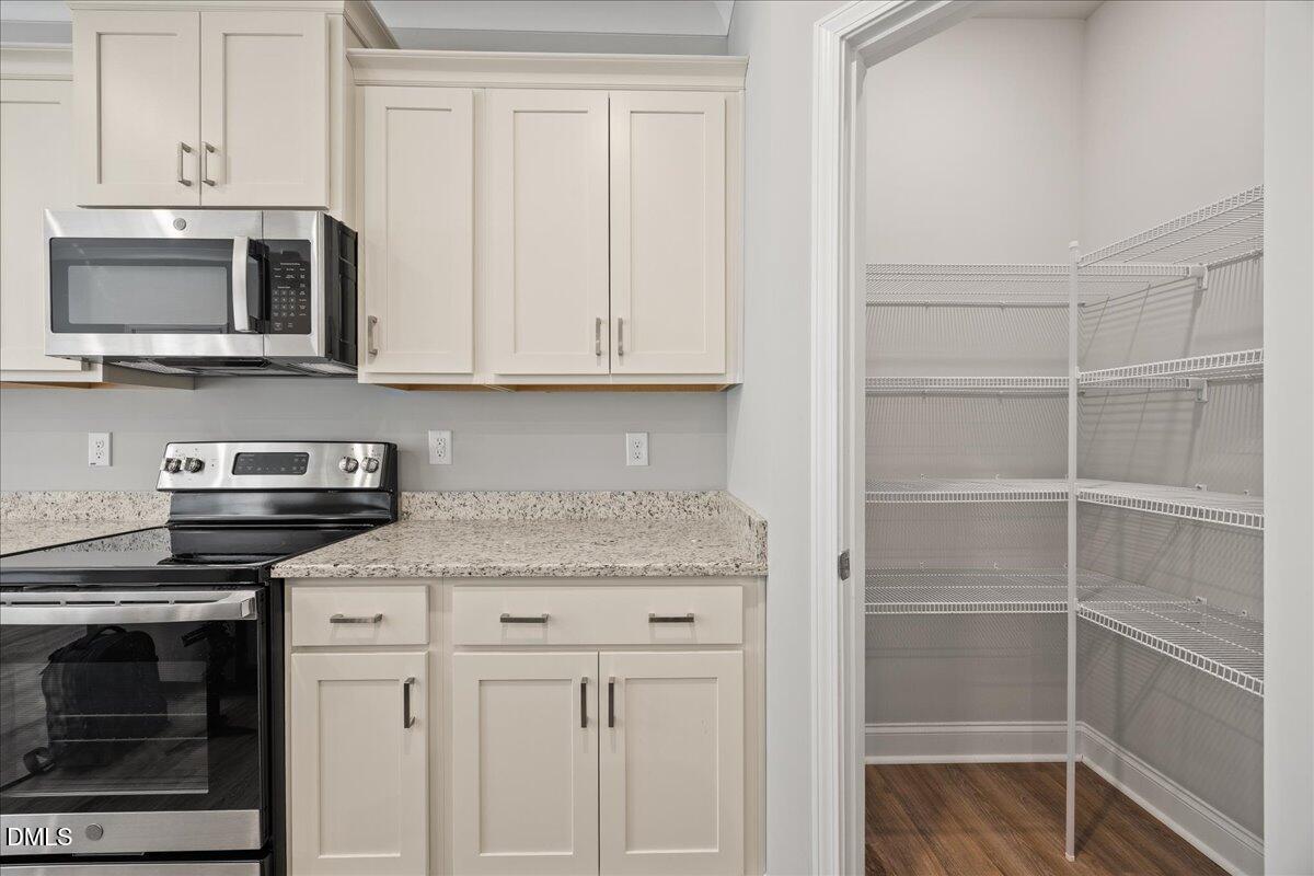 189 Red River Drive Selma, NC 27576 - Photo 11 of 31 a kitchen with stainless steel appliances granite countertop a stove microwave and cabinets