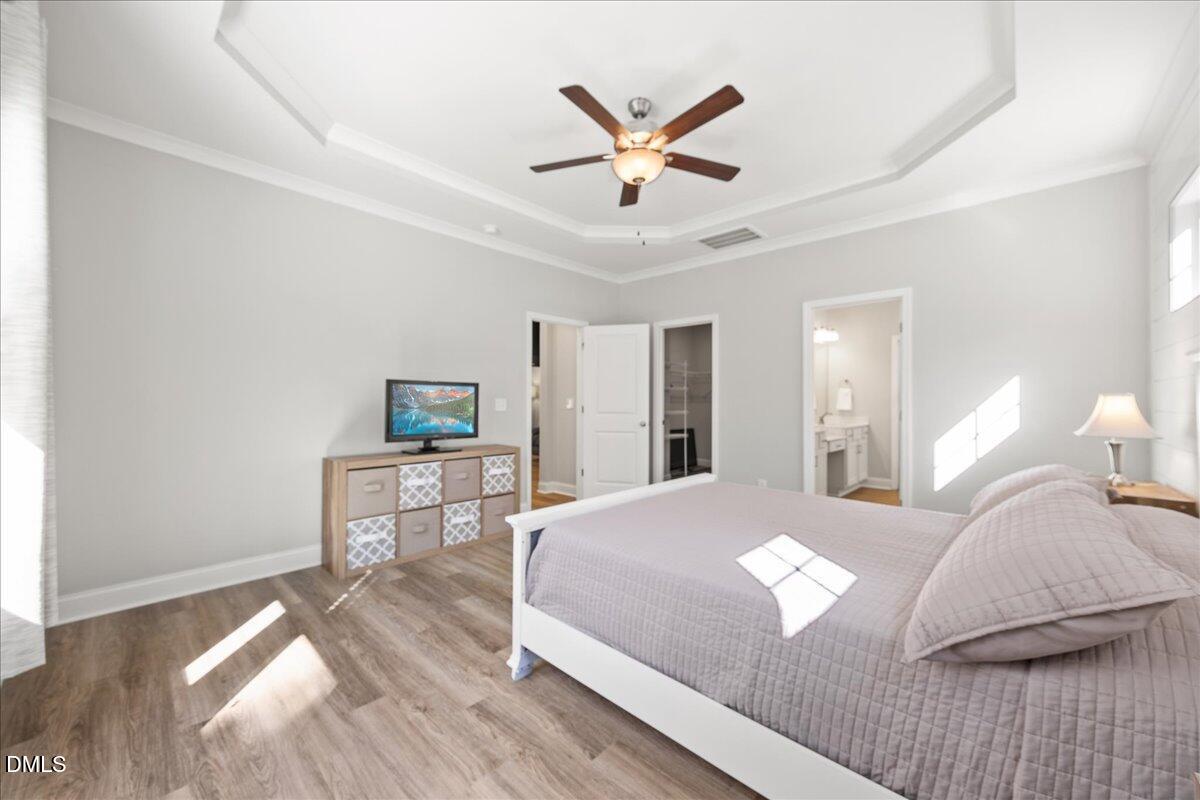 189 Red River Drive Selma, NC 27576 - Photo 17 of 31 a bedroom with a large bed and a chandelier