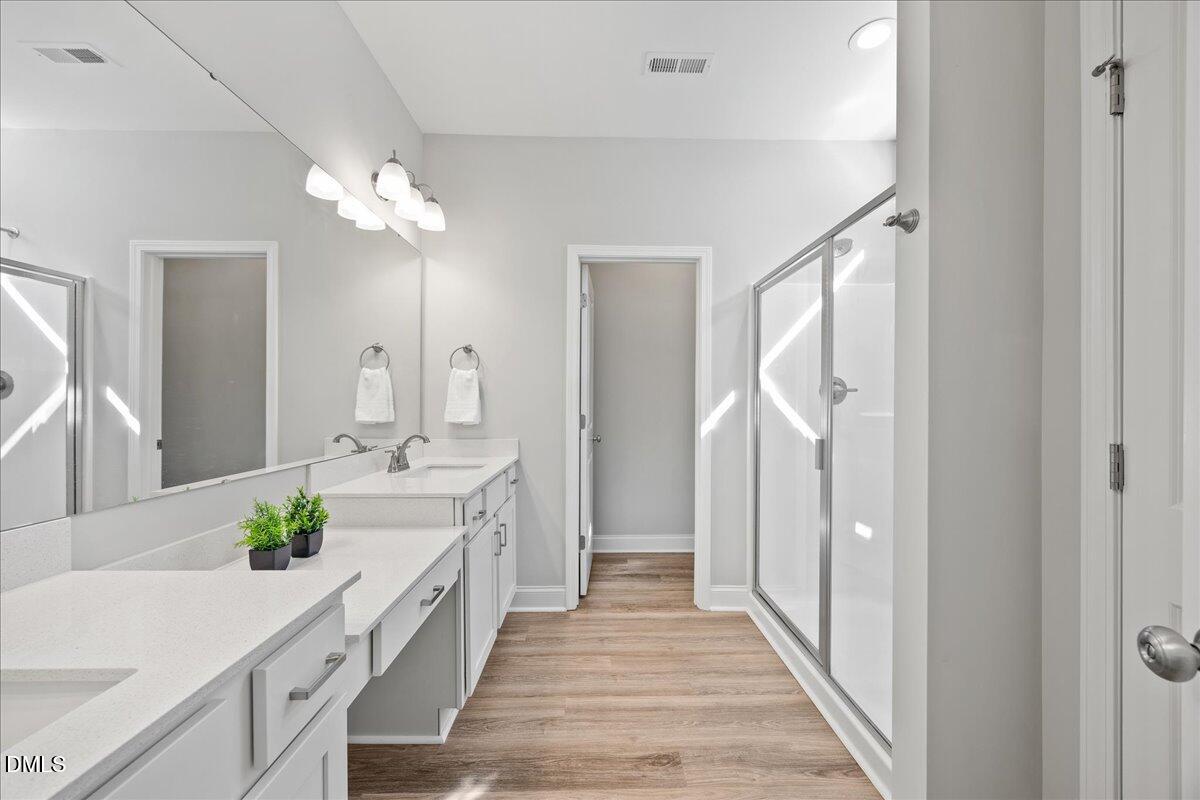 189 Red River Drive Selma, NC 27576 - Photo 20 of 31 a bathroom with a double vanity sink and a mirror