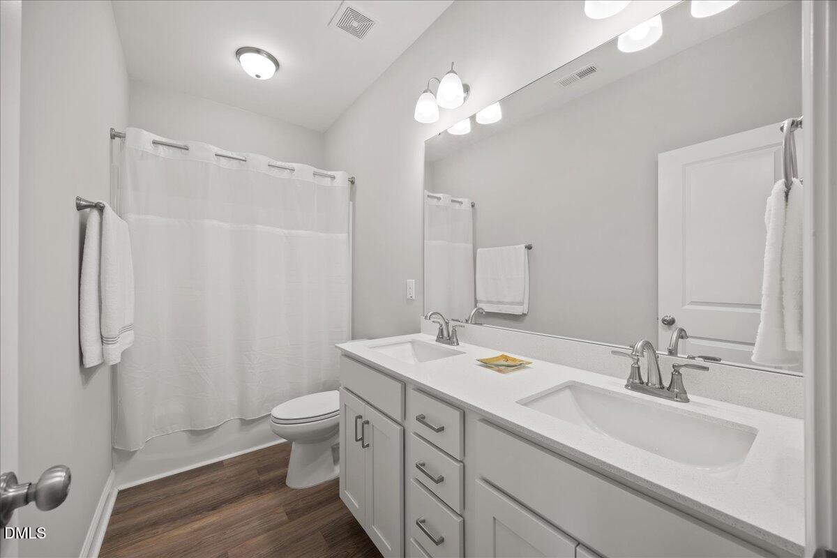 189 Red River Drive Selma, NC 27576 - Photo 21 of 31 a bathroom with a double vanity sink mirror and toilet