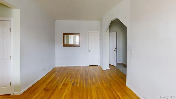 a view of a room with wooden floor