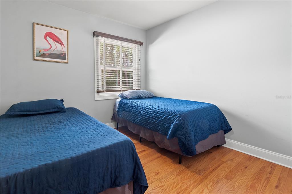 6515 Dimarco Road Tampa, FL 33634 - Photo 16 of 67 a bedroom with two beds and a window