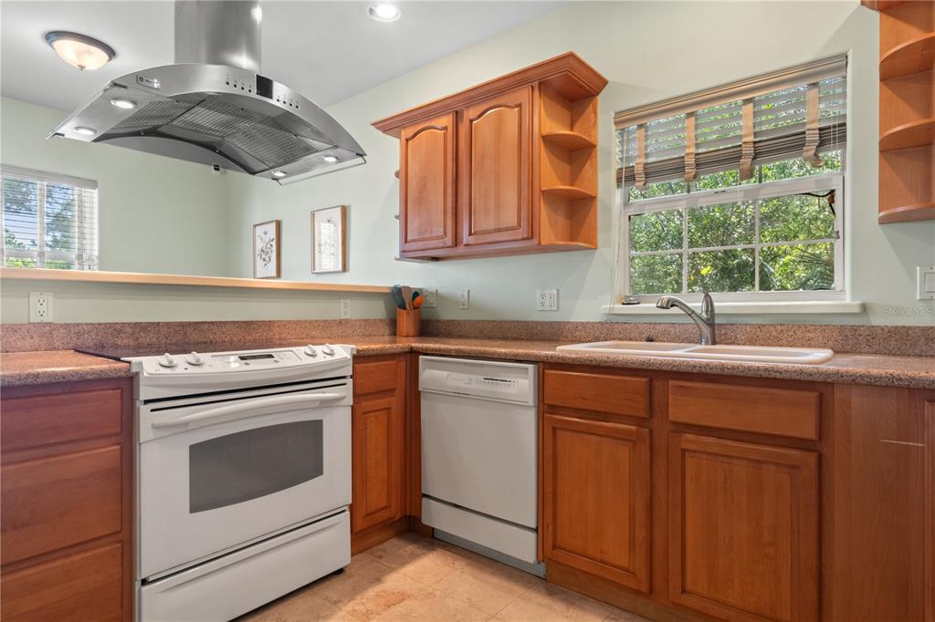 6515 Dimarco Road Tampa, FL 33634 - Photo 45 of 67 a kitchen with stainless steel appliances granite countertop a sink a stove and a microwave
