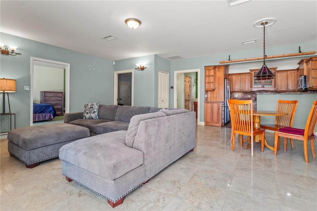 6515 Dimarco Road Tampa, FL 33634 - Photo 51 of 67 a living room with furniture and a floor to ceiling window