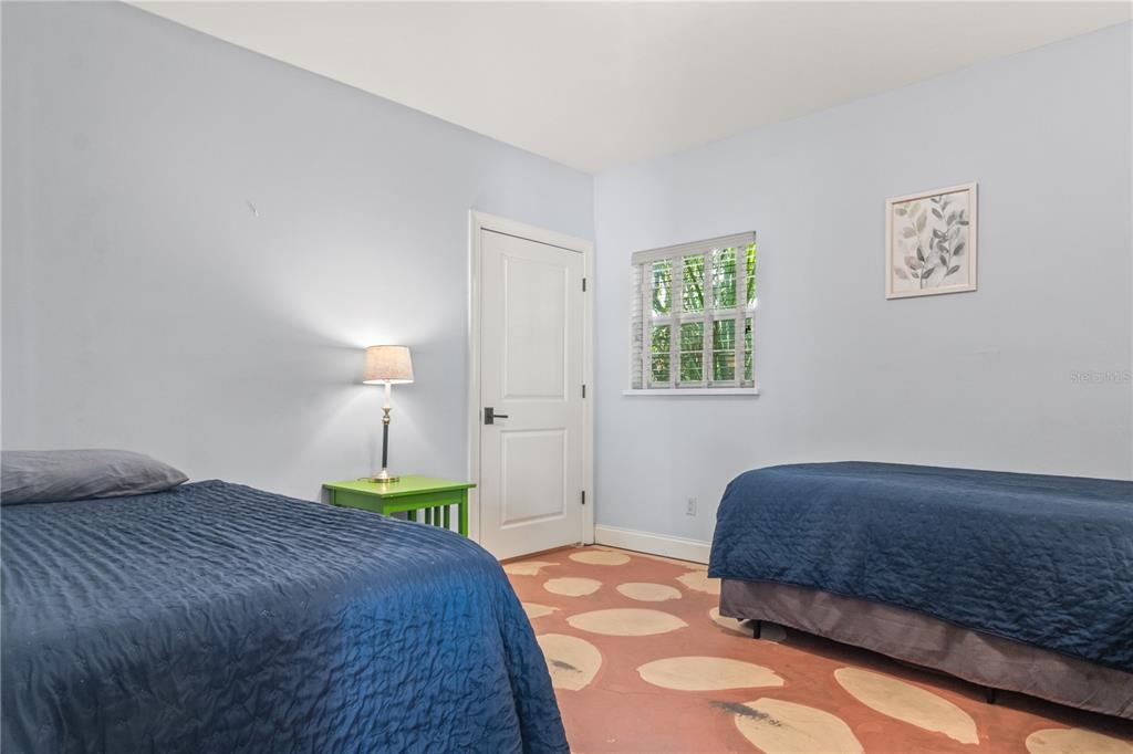 6515 Dimarco Road Tampa, FL 33634 - Photo 60 of 67 a bedroom with a bed and a lamp on dresser