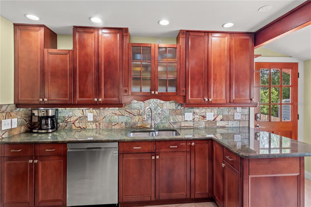 6515 Dimarco Road Tampa, FL 33634 - Photo 9 of 67 a kitchen with stainless steel appliances granite countertop wooden cabinets and a sink