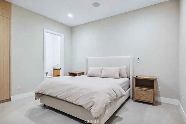 a bedroom with a bed and a night stand