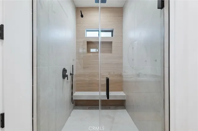 a bathroom with a window and a shower