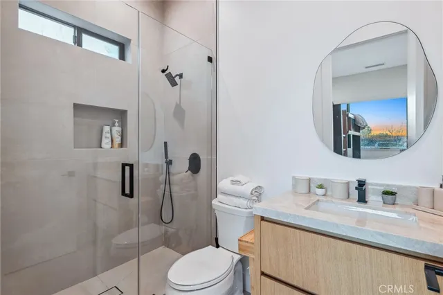 a bathroom with a granite countertop toilet sink and shower