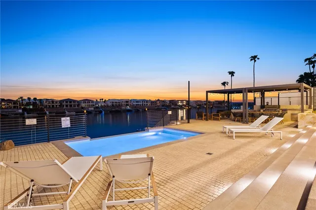 a view of a swimming pool with furniture