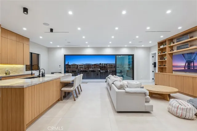 a living room with furniture a rug and white walls