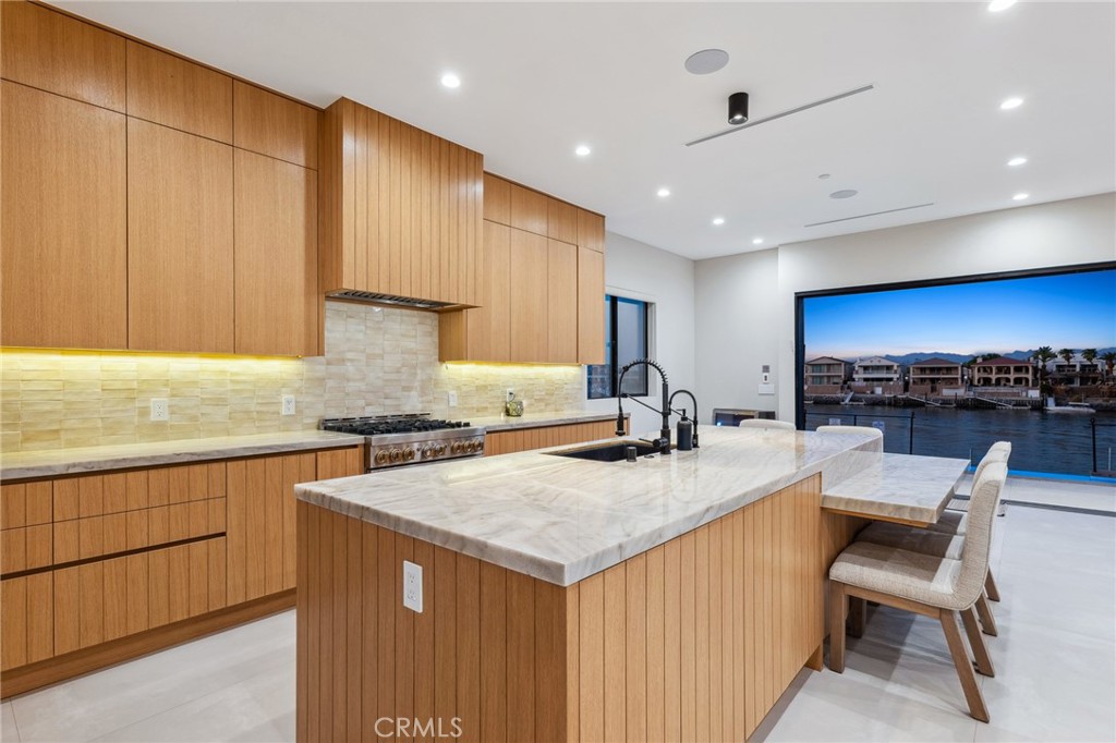 908 Beach Needles, CA 92363 - Photo 7 of 28 a kitchen with a stove a sink a kitchen island with a dining table and chairs