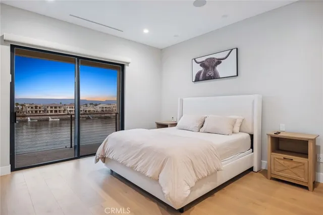 a bedroom with a large bed and a television