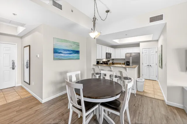 a dining room with furniture and wooden floor