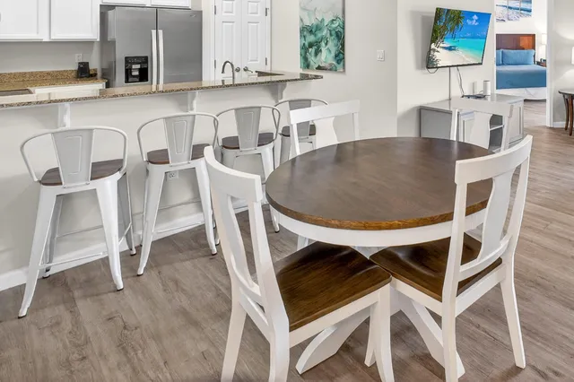 a kitchen with granite countertop a refrigerator a stove a sink a washer and cabinetry