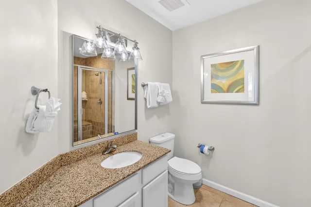 a bathroom with a glass shower door