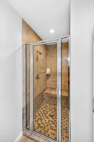 a bedroom with a large bed a chandelier and a window