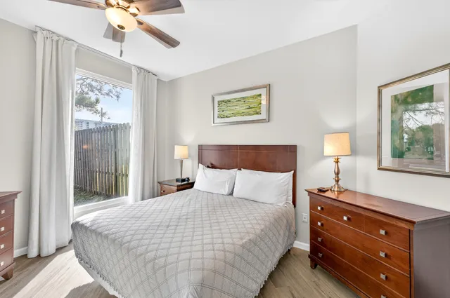 a spacious bedroom with a large bed and a chandelier