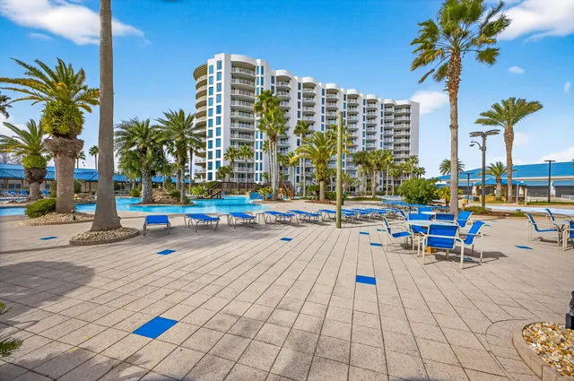a front view of a building with outdoor space and seating area