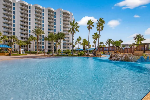 a swimming pool with outdoor seating and yard