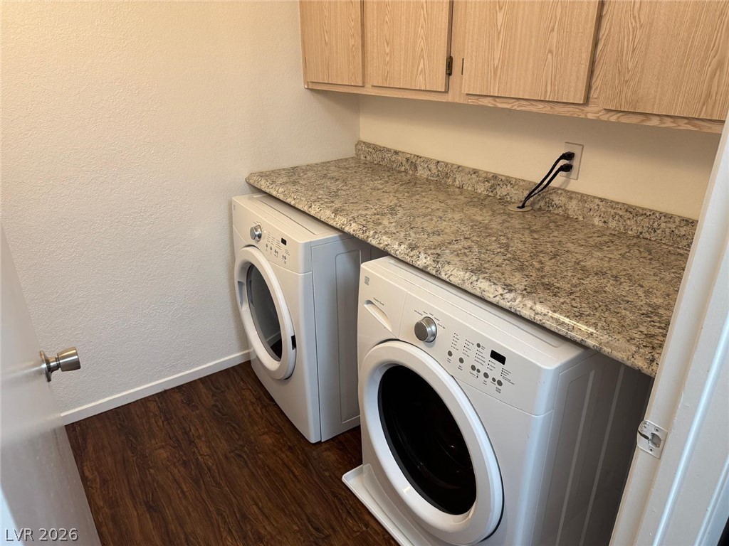 7885 West Flamingo Road, Unit 2171 Las Vegas, NV 89147 - Photo 19 of 22 Functional laundry room featuring a granite-like counter and ample cabinetry.