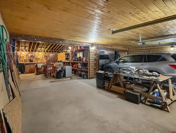 a bed sitting in a spacious bedroom next to a window