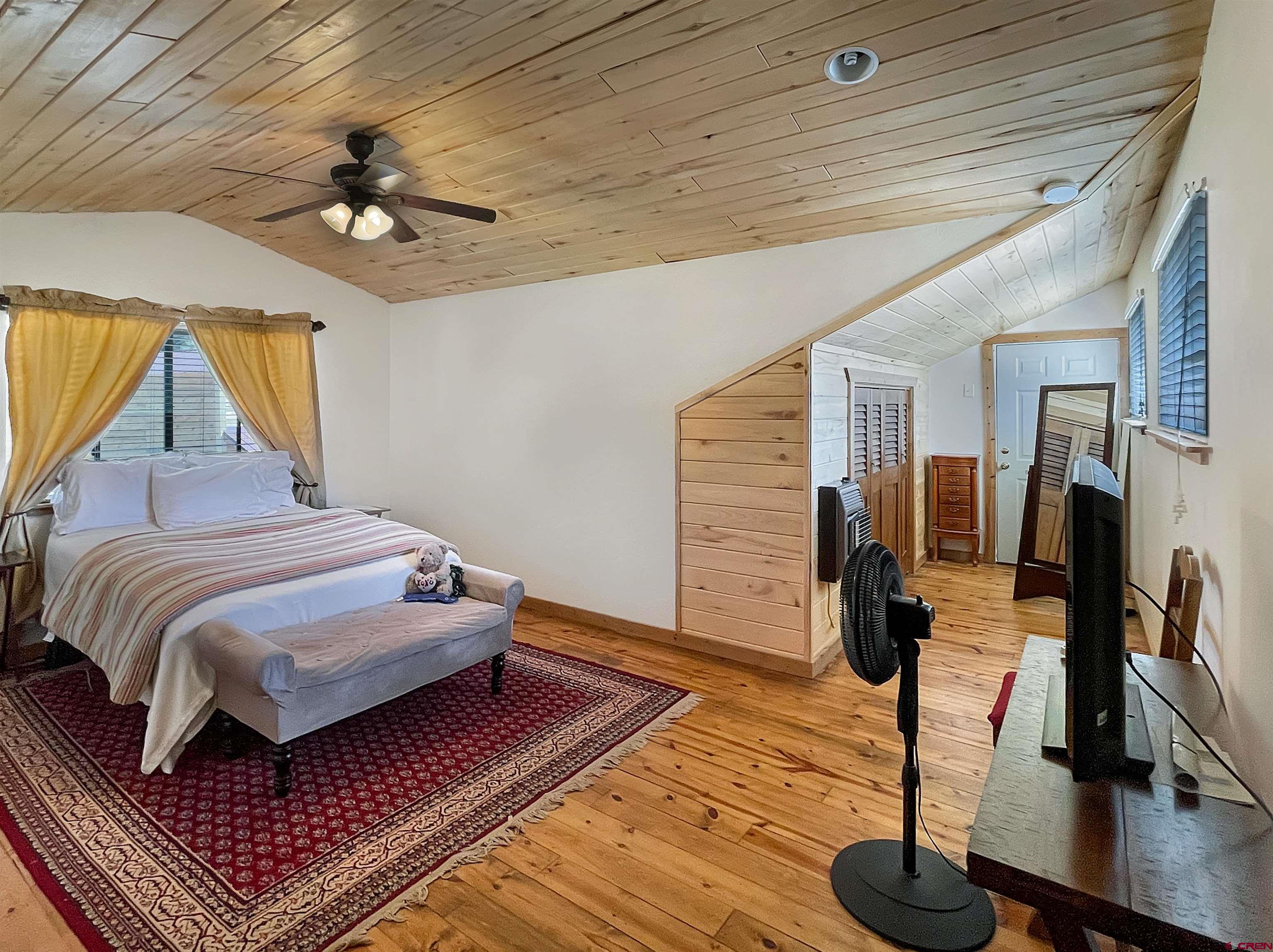 44750 Rd L Mancos, CO 81328 - Photo 23 of 45 a bedroom with a bed and a chandelier