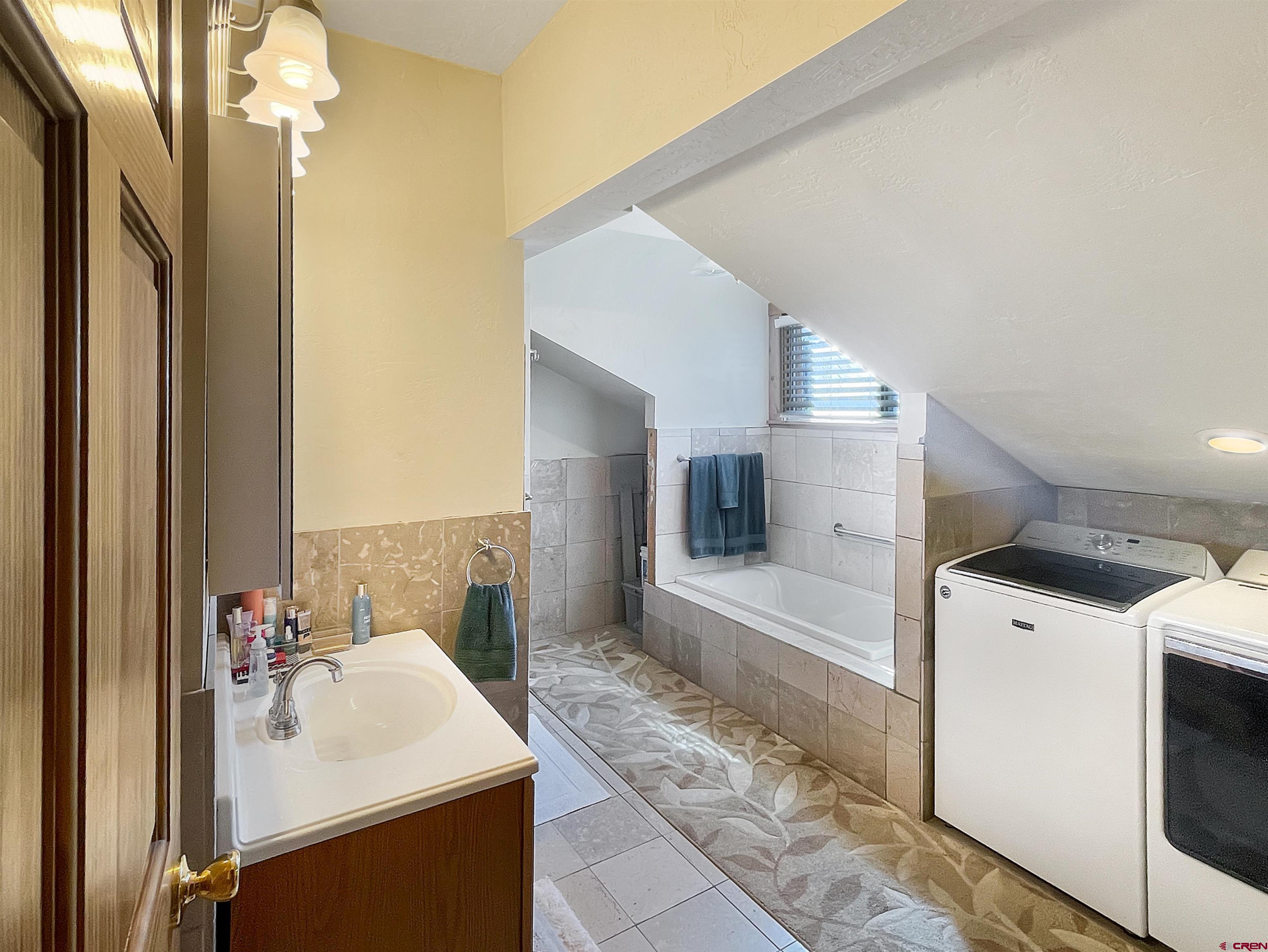 44750 Rd L Mancos, CO 81328 - Photo 24 of 45 a bathroom with a sink a toilet and shower