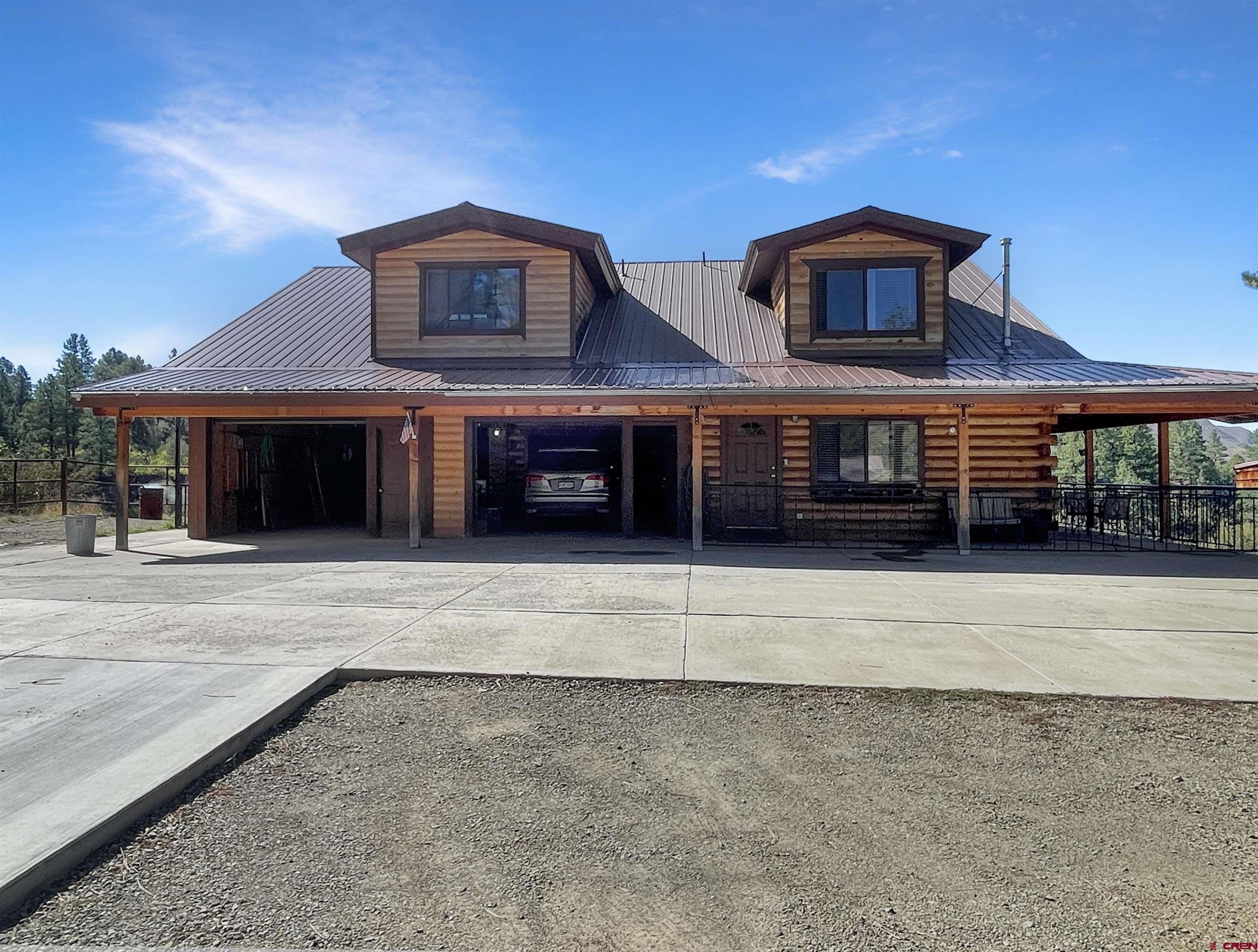44750 Rd L Mancos, CO 81328 - Photo 29 of 45 a front view of a house with a yard and garage