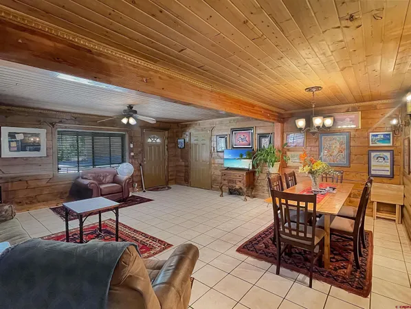 a living room with lots of furniture and chandelier