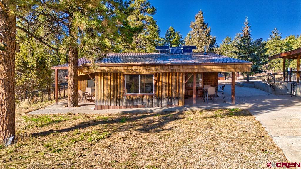 44750 Rd L Mancos, CO 81328 - Photo 34 of 45 a view of a house with a large tree and wooden fence