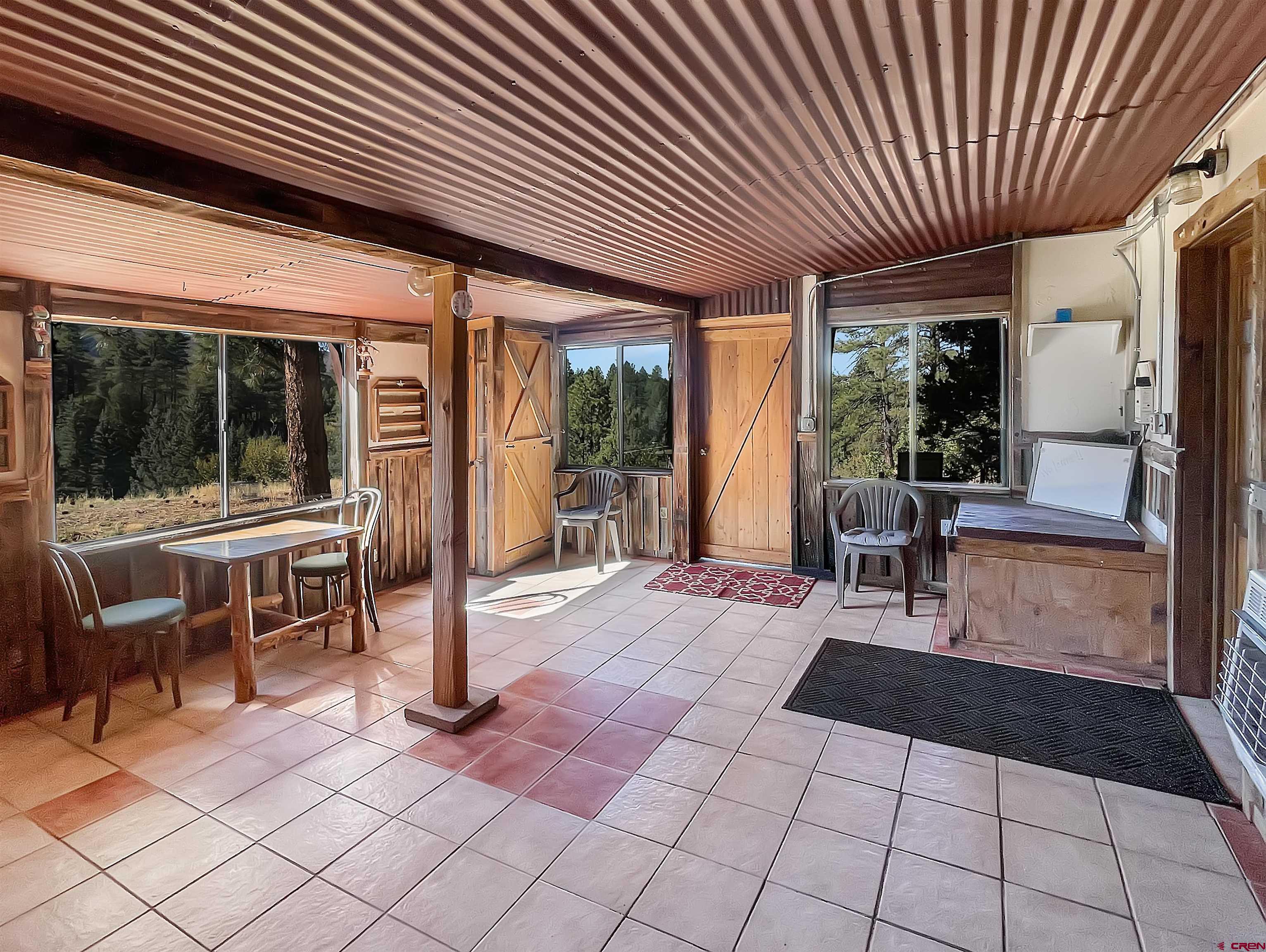 44750 Rd L Mancos, CO 81328 - Photo 35 of 45 a view of a patio with table and chairs with wooden floor and fence