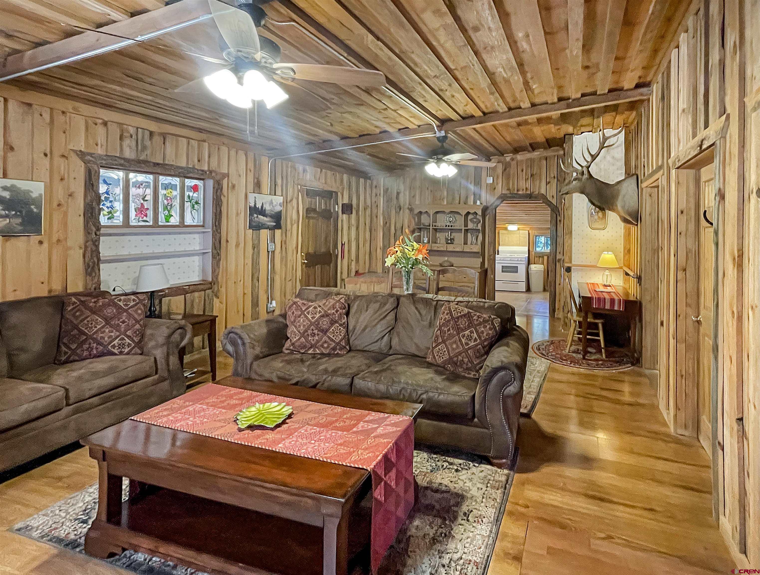 44750 Rd L Mancos, CO 81328 - Photo 37 of 45 a living room with furniture and a chandelier