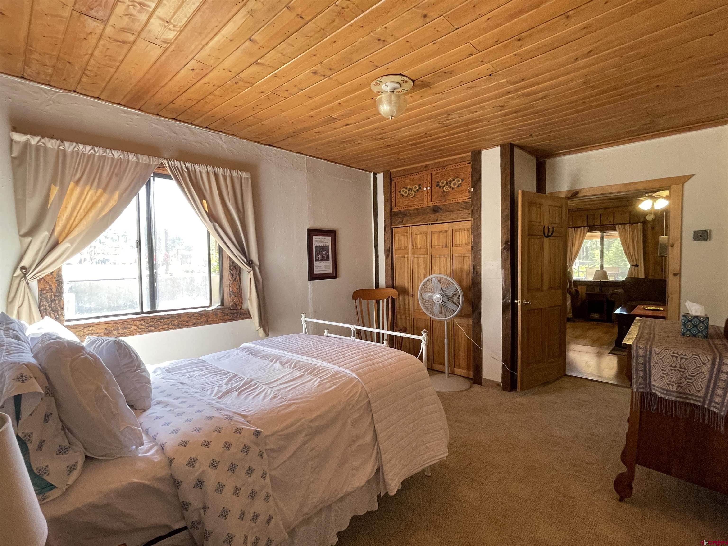 44750 Rd L Mancos, CO 81328 - Photo 41 of 45 a bed sitting in a spacious bedroom next to a window
