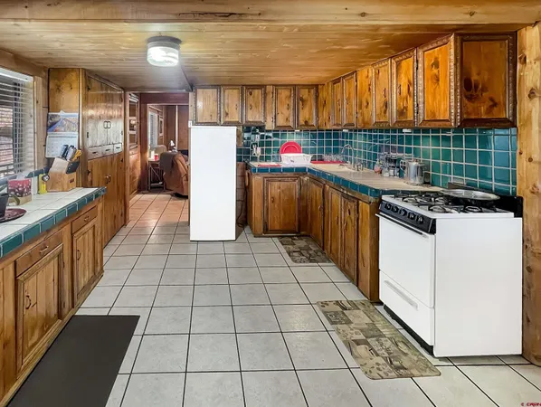 a kitchen with stainless steel appliances granite countertop a stove and cabinets