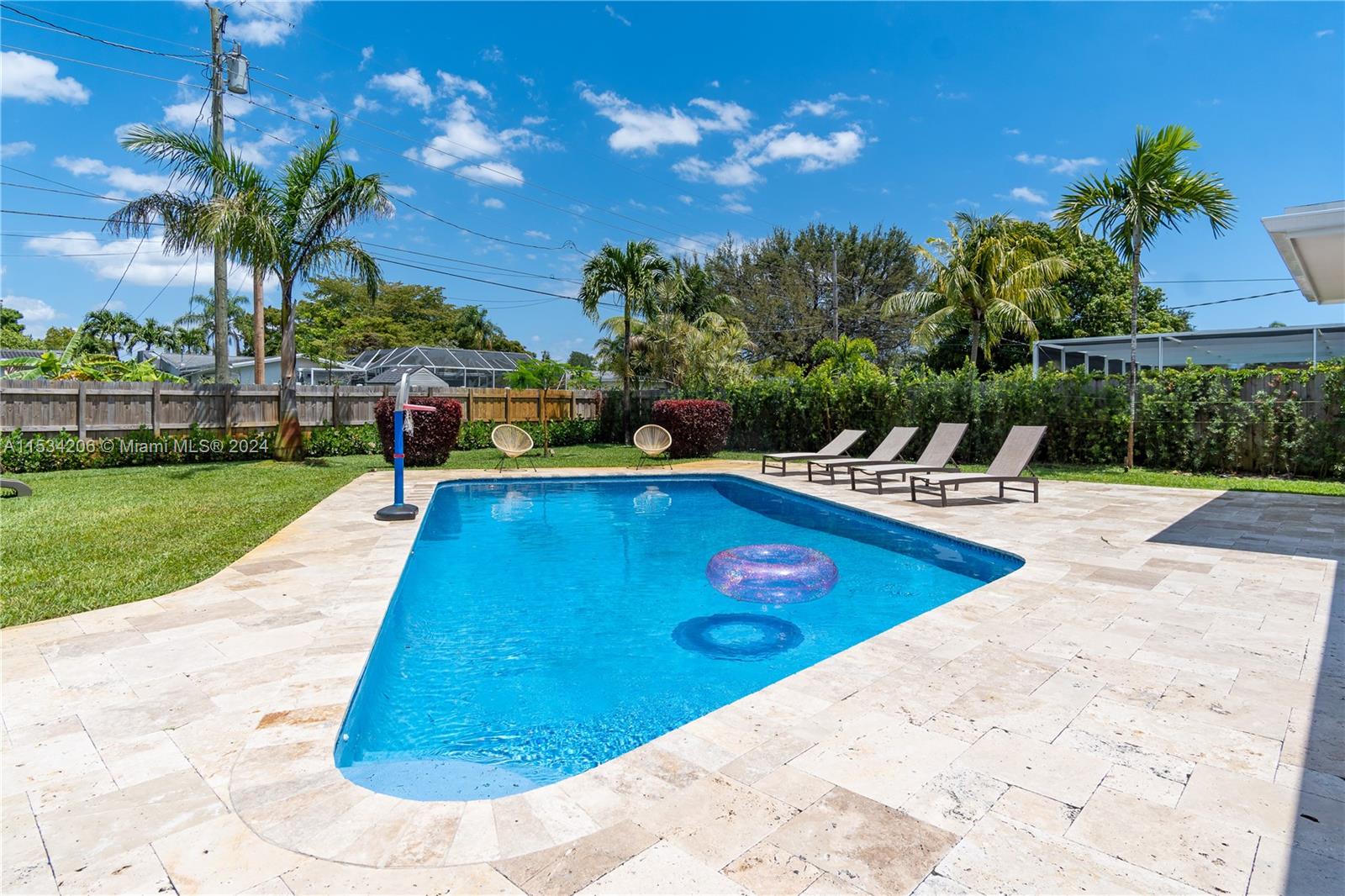 a view of a swimming pool with a patio and a garden