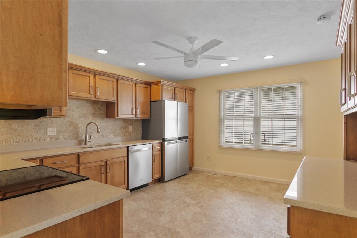 1707 Sunrise Point Normal, IL 61761 - Photo 12 of 23 a kitchen with stainless steel appliances granite countertop a sink stove and refrigerator
